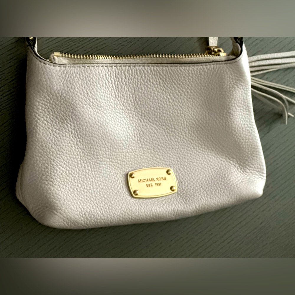Michael Kors cross body white bag with tassle